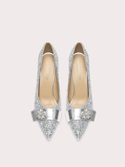 Pair of silver glittery high heels on a white background