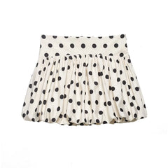 White skirt with black polka dots on a white background