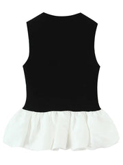 Black top with white ruffled hem on a white background