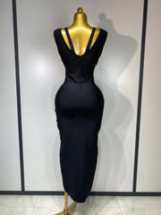 Black dress on a mannequin against a plain background