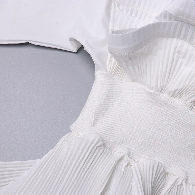 Close-up of a white pleated garment on a light gray background