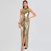 Woman wearing a metallic gold halter neck dress on a light gray background