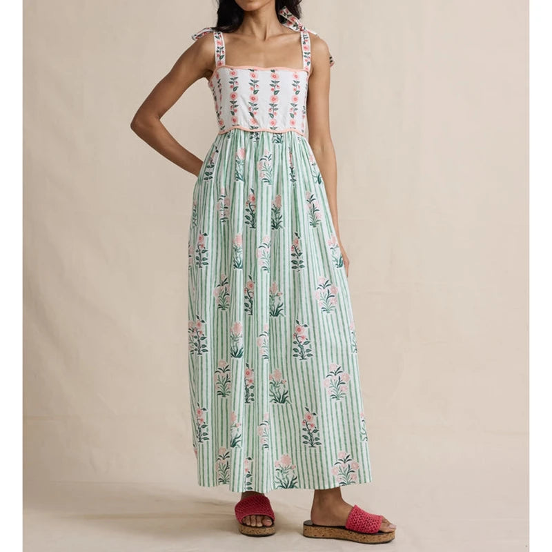 Maxi dress with floral print bodice, green striped skirt, and tie shoulder straps