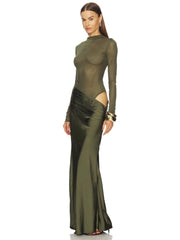 Woman wearing a green evening gown with cut-out design on a white background