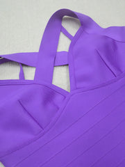 Close-up of a purple dress with thin straps on a light gray background