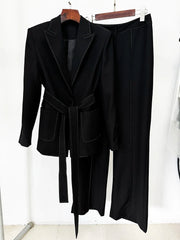 Black belted blazer and wide-leg pants suit with contrast stitching, displayed on a hanger, showing the front.