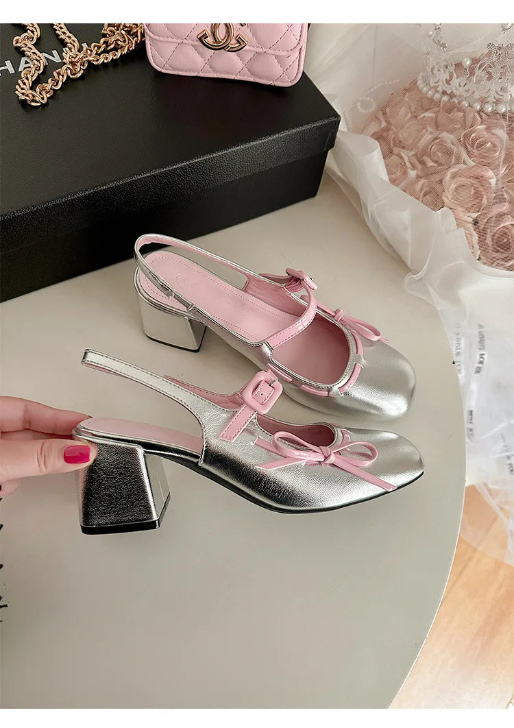 Silver patent leather chunky Mary Jane heels with pink trim and bowknot detail.