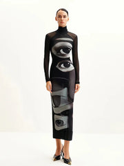 Model wearing a black dress with eye designs on a white background