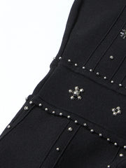 Black garment with silver stud details on a white background