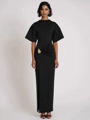 Woman wearing a black dress with a plain background