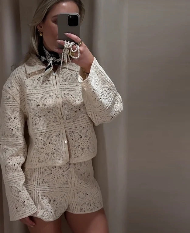 Person wearing a beige crochet outfit taking a mirror selfie.