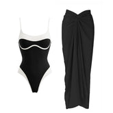Black and white contrast trim one-piece swimsuit and draped black sarong