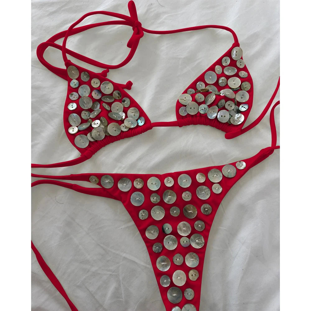 Red bikini set with circular iridescent button embellishments.