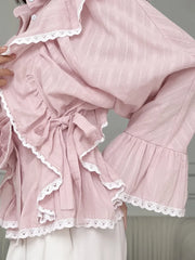 Pink outfit with lace details on a neutral background