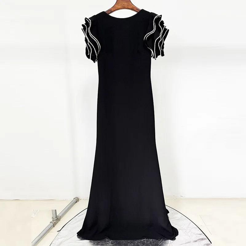 Black evening gown with white embroidery on a white background