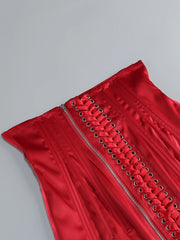 Red dress with lace-up details on a gray background
