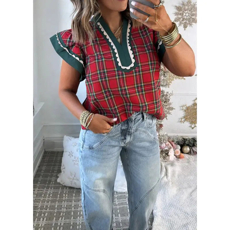 Close-up of plaid V-neck top with ruffle sleeves