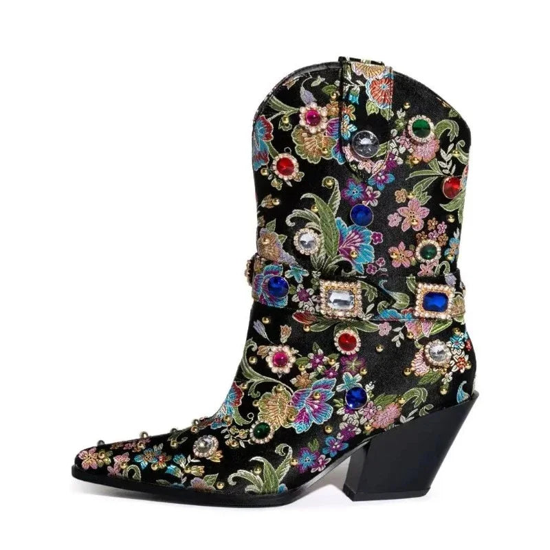 Close-up of a black embroidered pointed toe boot showcasing detailed floral embroidery and rhinestones.