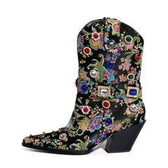Close-up of a black embroidered pointed toe boot showcasing detailed floral embroidery and rhinestones.