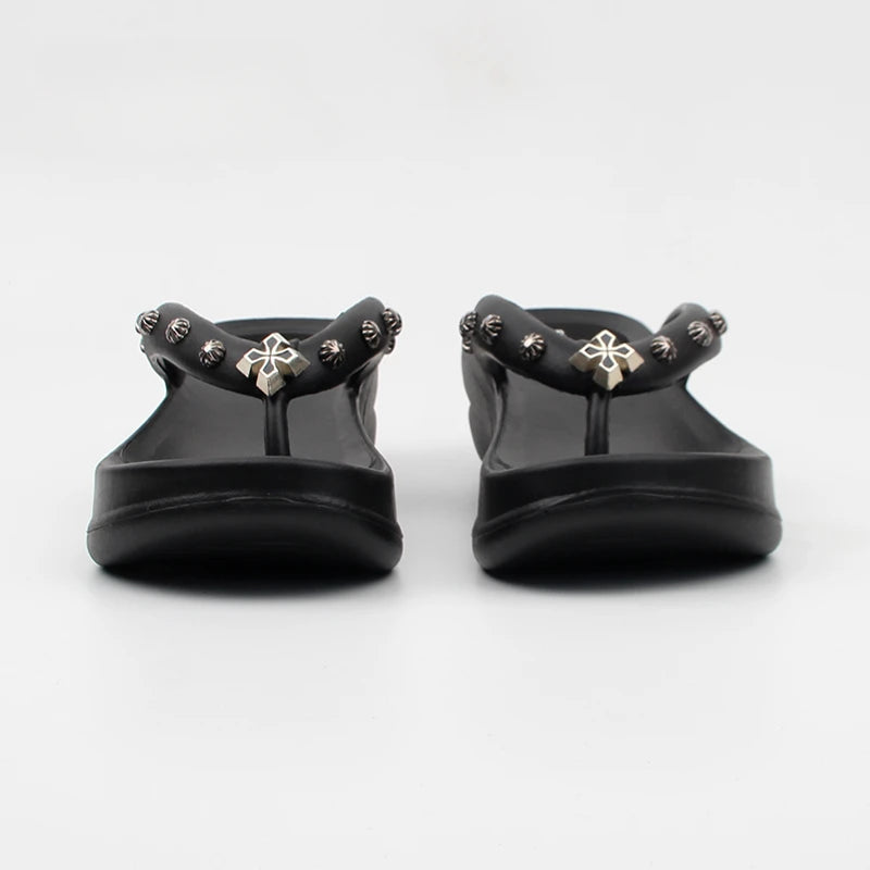 Front view of black platform thong sandals with silver metal stud details.