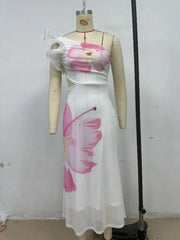 Mannequin wearing a white dress with pink floral patterns against a plain background