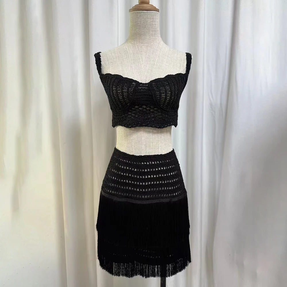 Mannequin displaying a black crocheted square neck crop top and fringe mini skirt.