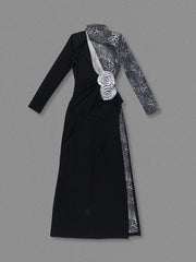 Black dress with floral details on a gray background