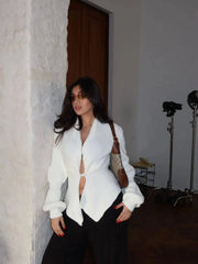 Asymmetrical ribbed knit coat with V-neckline and single button closure.
