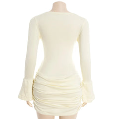 Mannequin wearing a cream-colored dress with long sleeves on a white background