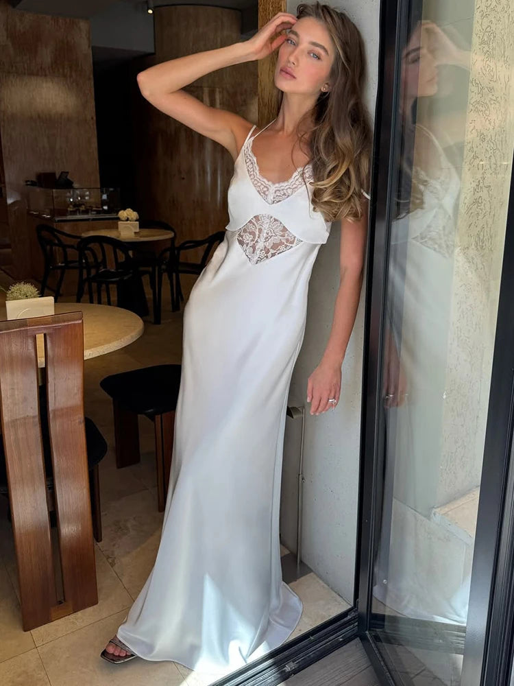 Woman in a white dress standing in a restaurant setting