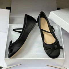 Nude pink and black satin mary jane ballet flats displayed