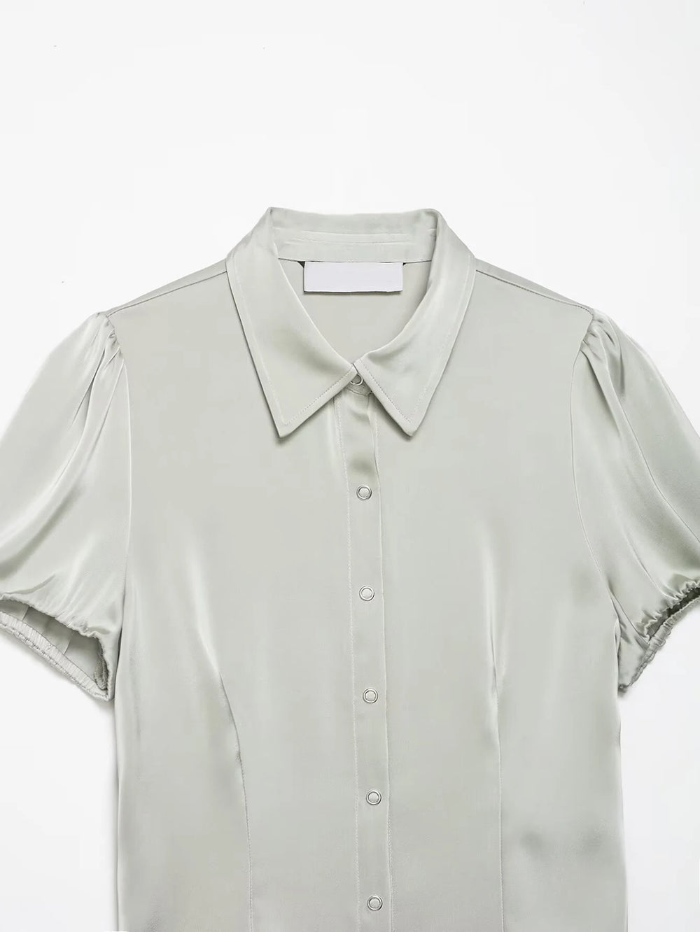 Close-up of collar and sleeves on satin puff sleeve collared shirt