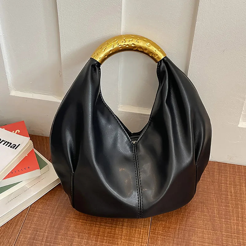 Black soft PU leather dumpling shaped handbag with a textured gold metal handle.
