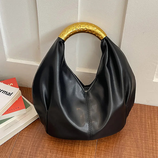 Black soft PU leather dumpling shaped handbag with a textured gold metal handle.