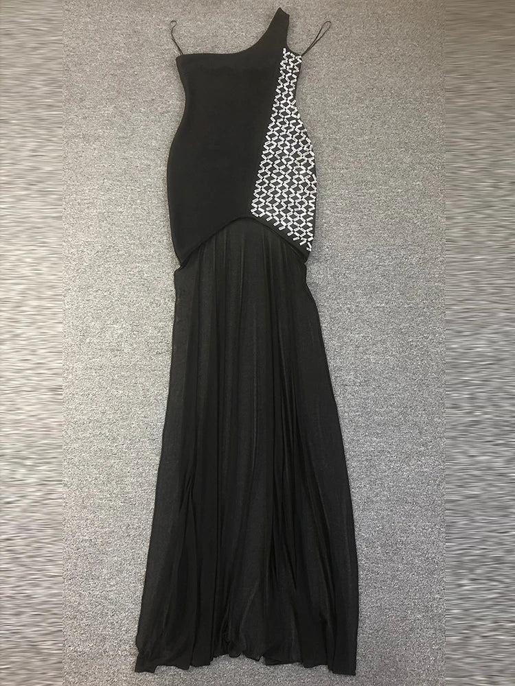 Black evening gown with geometric pattern on a textured gray surface