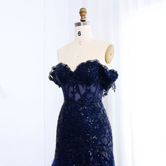 Navy blue sequin dress on a mannequin against a white background
