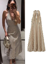 Striped halter neck midi dress worn by a model