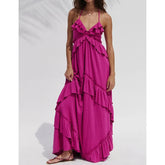 Magenta ruffled halter maxi dress with flowing skirt.