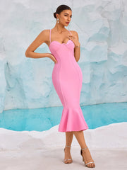 Woman wearing a pink dress against a textured blue and white background