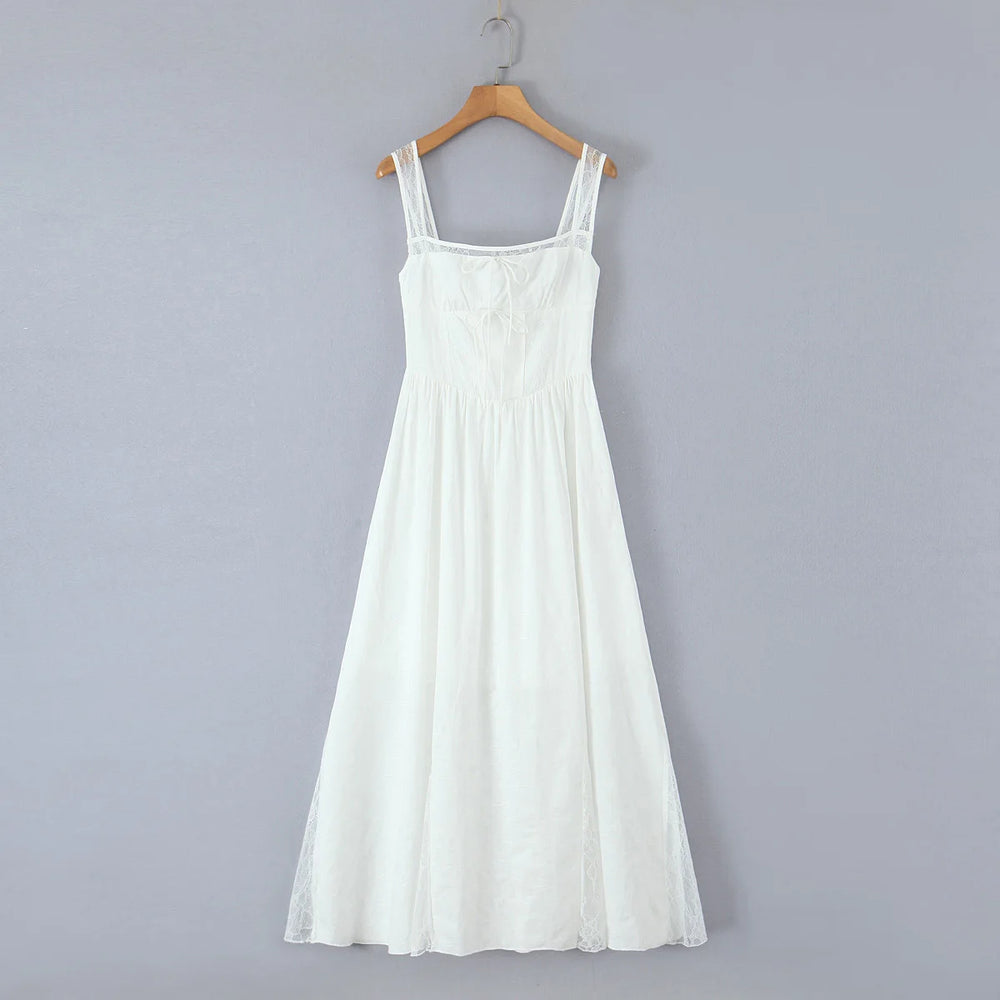 White dress on a wooden hanger against a gray background