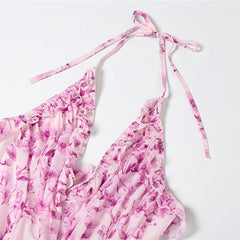 Pink floral bikini top with tie straps on a white background