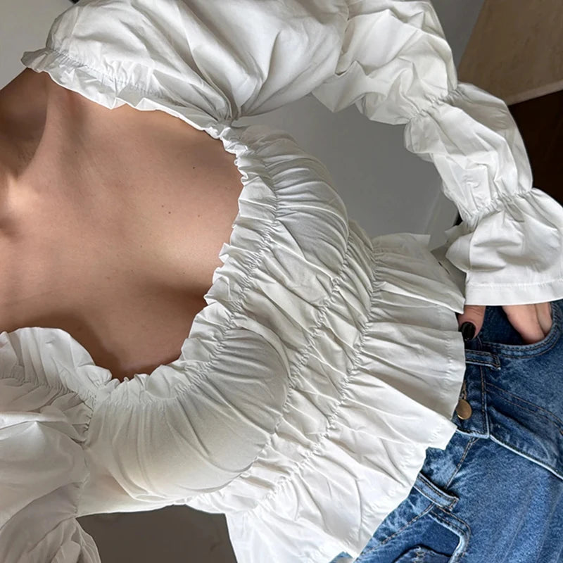 Close-up detail of smocked square neck puff sleeve white top