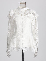 White lace blouse on a mannequin against a gray background