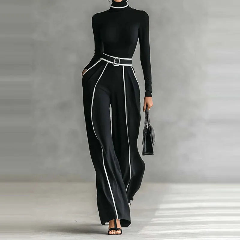 Black outfit with white trim on a neutral background