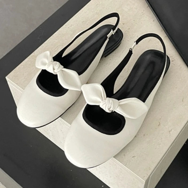 White matte bow slingback pumps with round toe