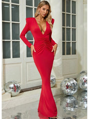 Woman in a red dress standing in a room with disco balls.