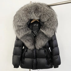 Black puffer jacket with large fur hood on a mannequin against a white background