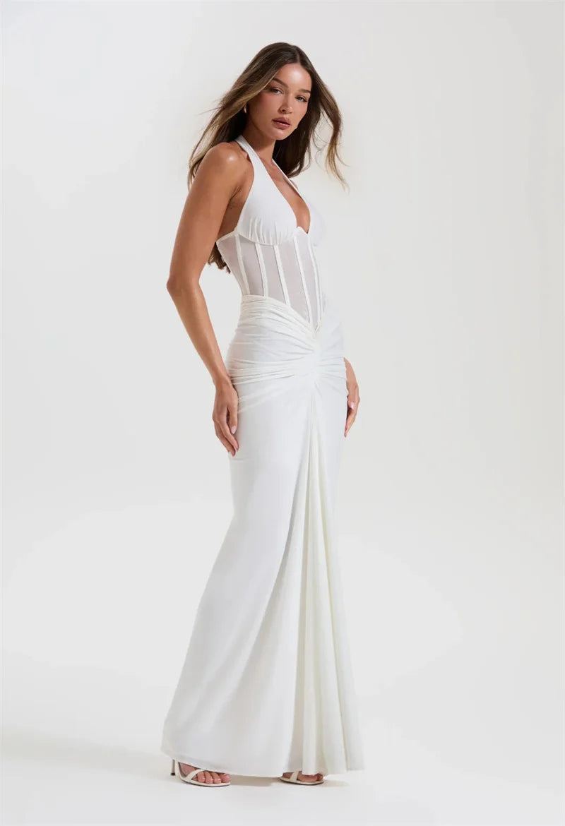 Woman wearing a white dress with a halter neck design