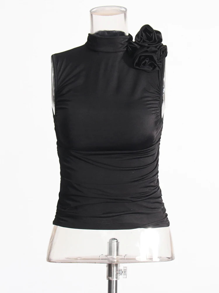 Black sleeveless top with floral details on a mannequin against a white background
