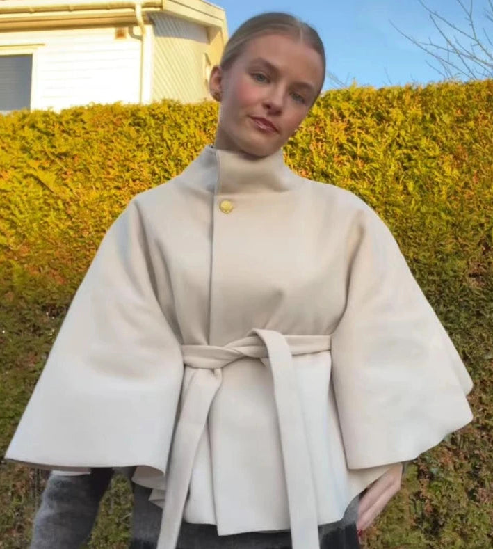Beige stand collar belted cape coat detail